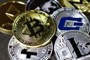 Close-up view of assorted cryptocurrency coins featuring Bitcoin, Litecoin, and others, symbolizing digital finance.